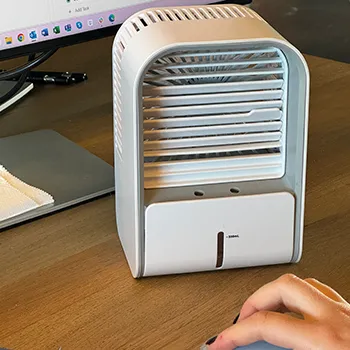 FrostCooler personal cooler running on a desk beside a monitor